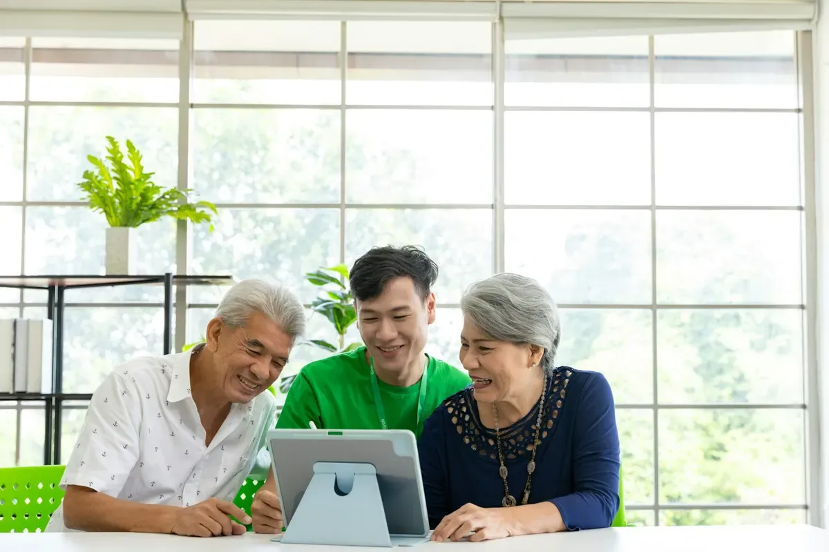 Two people sitting together comparing home care options.