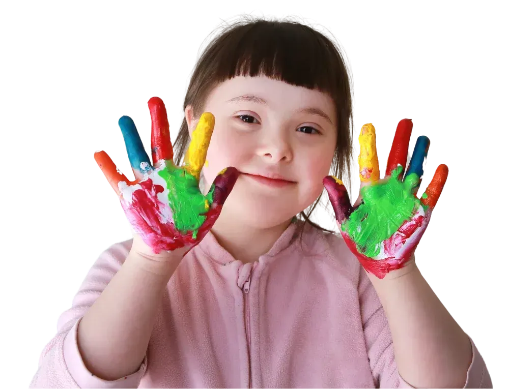 A smiling child holding up hands covered in colourful paint