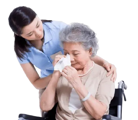 A nurse gently caring for an older woman at home